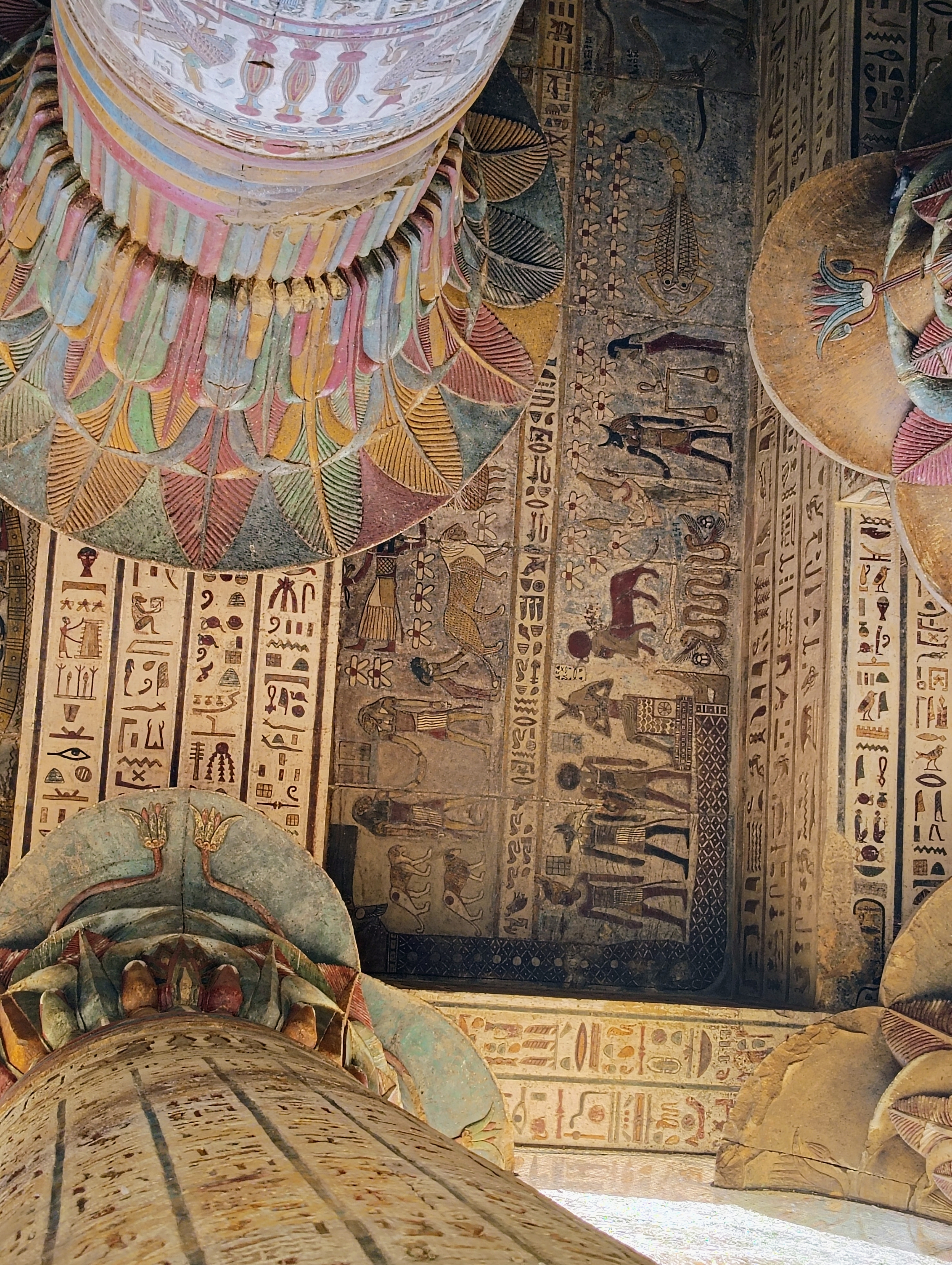 Lotus column capitals at Esna Temple, Egypt, alongside a zodiac ceiling depiction showing Scorpio, Libra, and Gemini